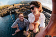 © Angel Santana/Stocksy - Travelers taking selfie laughing at natural rock pools