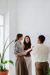 © Nuria Seguí/Stocksy - Colleagues discuss ongoing project