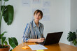 © Nuria Seguí/Stocksy - Elegant woman works on her laptop