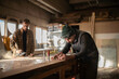 © Niyaz Tavkaev/Stocksy - Men working with wood in joinery