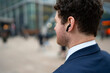 © Artcore Studio/Stocksy - Man wearing earbuds in city