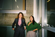© Boris Jovanovic/Stocksy - Two businesswomen smiling at the camera