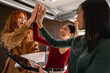 © VICTOR TORRES/Stocksy - Diverse team celebrating success with a high five