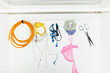 © Colour Laboratory/Stocksy - Colourful funny daily life objects hanging from hooks with flashlight