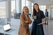 © BONNINSTUDIO/Stocksy - Business partners looking at camera in modern office workplace