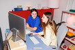 © Artem Podrez/Stocksy - Women teamwork at desk in stylish home office with flash