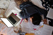 © Danil Nevsky/Stocksy - Exhausted student sleeping on study materials in bed