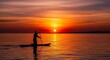 © Ilham - Silhouette paddleboarder on water at sunset peaceful scene copy space
