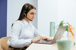 © Manu Padilla/Stocksy - Woman working on laptop for customer support service