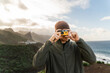 © Alba Studio/Stocksy - Traveler taking photo on Tenerife coast