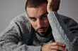 © ohlamourstudio/Stocksy - Man Resting His Head on His Hand in a Casual Indoor Setting