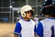 © Guille Faingold/Stocksy - Batter and catcher talking during a baseball practice