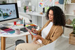 © Pixel-Shot - Female African-American interior designer with color palette in office