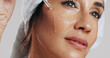 © peopleimages.com - Skincare, thinking or woman with serum in studio, apply hyaluronic acid or anti aging facial treatment. Dropper, dermatology or mature person with product for glowing skin, vision or white background