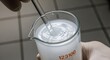 © AbdulJaafar - Stirring a cloudy liquid in a laboratory beaker