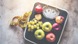 © ugochi - Fruits on scale with measuring tape emphasizing urban lifestyle and city dynamics