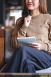 © Farknot Architect - Vertical closeup image of a woman thinking and writing on a notebook