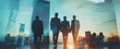 © saheda - Silhouettes of businesspeople walking with blue skyscrapers and warm sunlight holding hands team