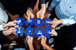 © InfiniteFlow - A diverse team gathers around a puzzle, using hands to symbolize collaboration, ideas, and strategies. Icons on pieces represent various concepts related to success in business. Amity
