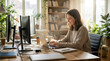© Template_Design - Young woman working on laptop at desk with dual monitors in cozy home office filled with natural light and plants, smiling and focused on task