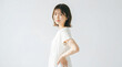 © k-studio - Side view of a Japanese woman standing with hands on hips against white background