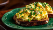 © Oleksiy - Diet scrambled eggs on toasted brioche bun on green plate