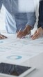 © rogerphoto - Professional team collaborating, reviewing financial graphs, calculating metrics, discussing performance insights and strategic planning in modern corporate workspace. Business people concept