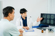 © Nuttapong punna - Doctor explaining brain scan results to patient in clinic. Healthcare, neurology, diagnosis, medical consultation