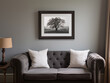 © Anna Studio - Modern living room interior with a gray tufted sofa, white pillows, and framed fine art on a solid gray wall