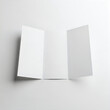 © SUMMA - Two sheets of paper folded at an angle against a plain background