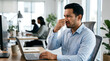 © solom - Man in office reacting to bad smell holding his nose while working on laptop representing unpleasant workplace environment or office sanitation issue