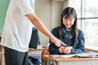 © buritora - A teacher and a female student using smartphones during class (BYOD/ICT)