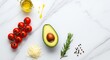 © Sutelor - Healthy cooking ingredients with avocado tomatoes and olive oil on marble background