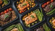 © Ahmadulinnuha - Multiple portions of prepared healthy meals ready for storage and consumption are arranged closely together.