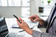 © Fahng - Professional business man in office holding mobile cellphone. technology device at work.