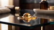 © Thipsuda - Glass surface reflection golden liquid modern table luxury interior elegant decor soft lighting contemporary style smooth texture home detail warm ambiance closeup relaxation
