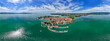 © AmazingAerialAgency - Aerial view of Lindau, a vibrant island city, where red-roofed buildings meet the shimmering turquoise waters of Lake Constance, Lindau, Bavaria, Germany.