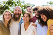 © Xavier Lorenzo - Diverse group of young friends laughing and hugging outdoors. Happy people enjoying fun moments together with strong friendship and positive energy on a sunny day. Lifestyle and diversity concept.