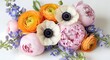 © shamm - A vibrant bouquet of assorted colorful flowers, including anemones, peonies, and ranunculus, artfully arranged on a white background