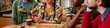 © AnnaStills - Website banner of friends sharing tea during casual group conversation at home