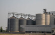 © Rangsarit - Exterior view of a large-scale animal feed mill plant or grain terminal.Large industrial grain silo complex and food processing factory building.