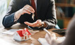 © Konstantin Yuganov - Real Estate Agent Handing Keys to New Homeowner in Office Setting