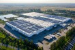 © Mateusz - An aerial view of a large industrial complex, featuring vast buildings, rooftops, and surrounding landscape