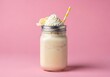 © Joko - Creamy blended beverage topped with whipped dairy confection and fruit slices sits against a bright pink backdrop