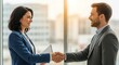 © tian - Businessman and businesswoman shaking hands.