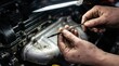 © Yauhen - Dirty hands holding an oil dipstick over a car engine. Professional vehicle maintenance and inspection process. Ideal for automotive repair services and technical manuals.