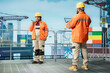 © DC Studio - Offshore platform experts uses performance management software on device to reduce downtime. African american coworkers use tablet app integrating sensor readings to manage industrial barge operations