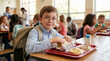 © ViskBx - Young boy with glasses eating lunch in a school cafeteria