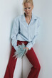© Serge Filimonov/Stocksy - Bold fashion portrait of woman in blue shirt