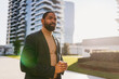 © Dimitrije Tanaskovic/Stocksy - Elegant man stands outdoors